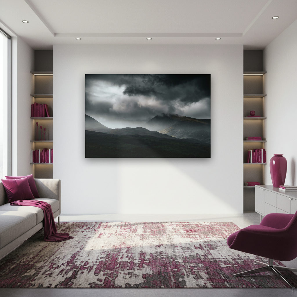 Dunkle, dramatische Wolken über einer Berglandschaft in Schottland, mit Lichtstrahlen im Nebel.