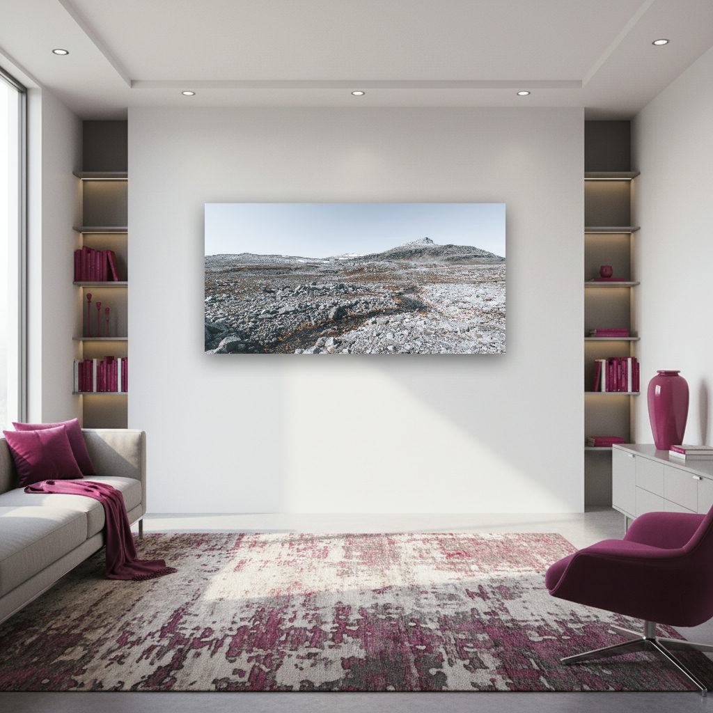 Weite, steinige Fjell-Landschaft in Skandinavien mit einem Bach und schneebedeckten Bergen.